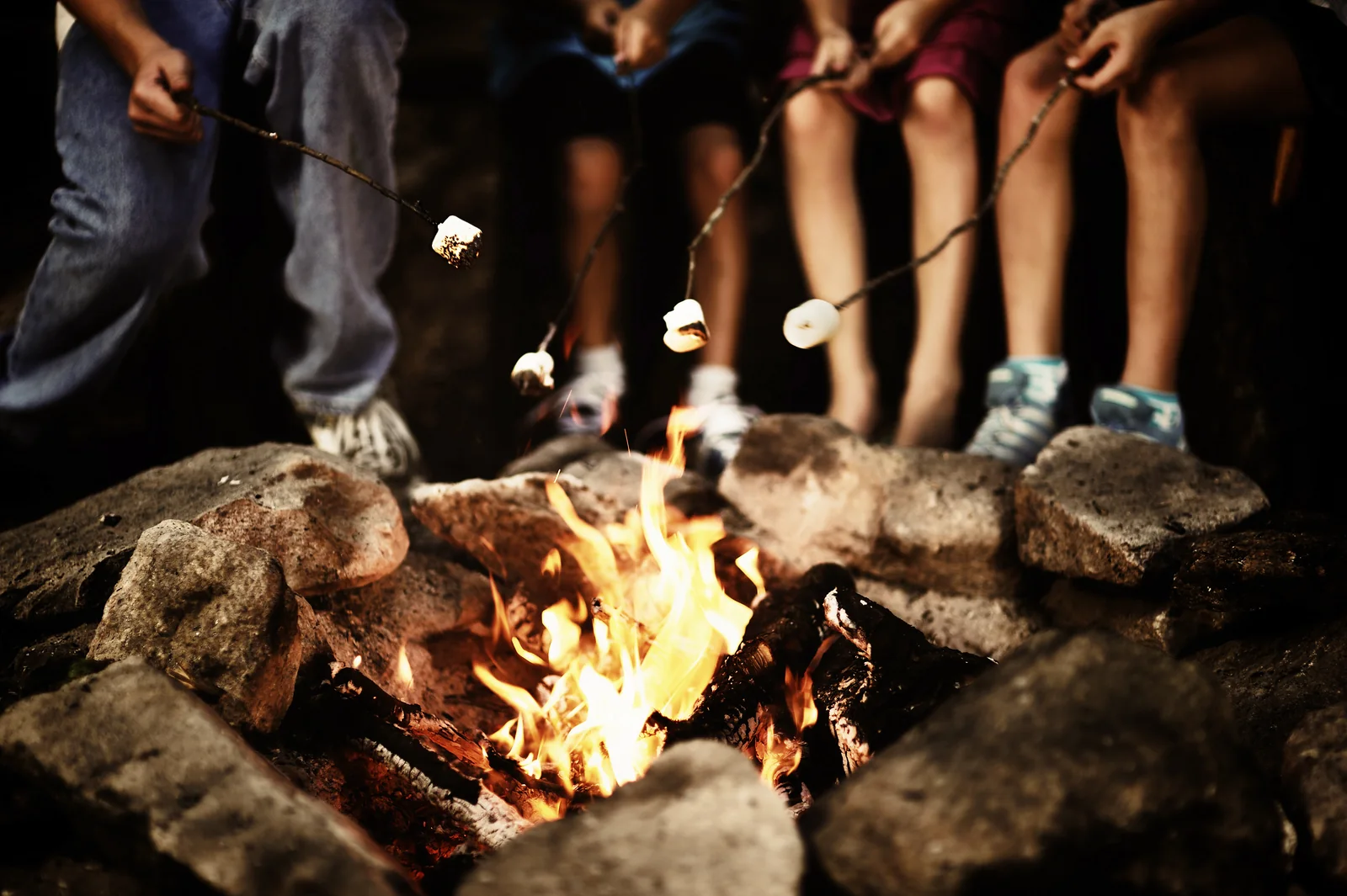 Marshmallows being toasted over a campfire