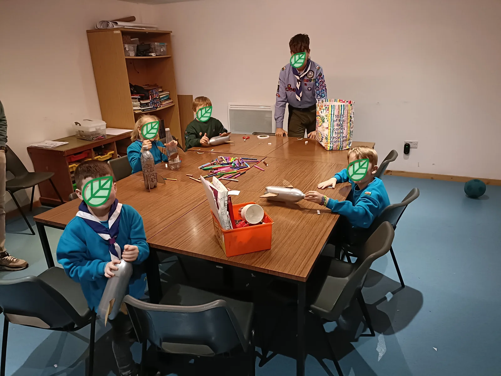 A craft activity around a table in the hut